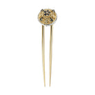 A gold-colored chignon fork with a decoration of European crystals on the top.